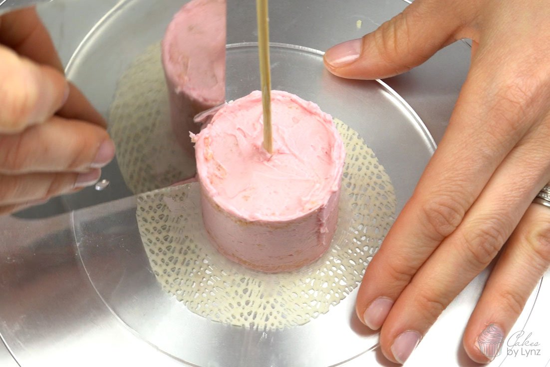 adding a bamboo skewer to hold mini cake