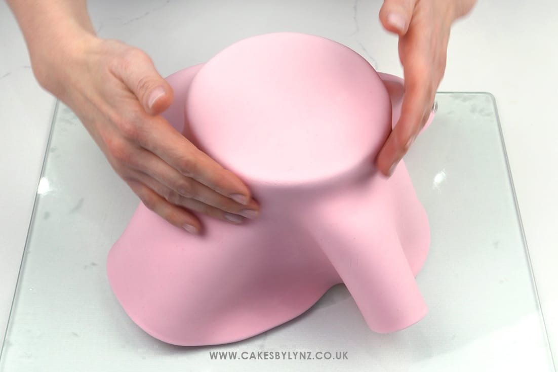 covering a cake in fondant
