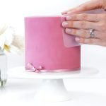 Covering a cake in fondant using the panelling method